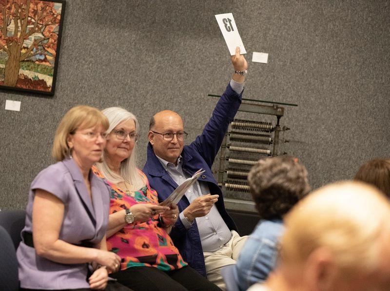 Man holds up number during art auction